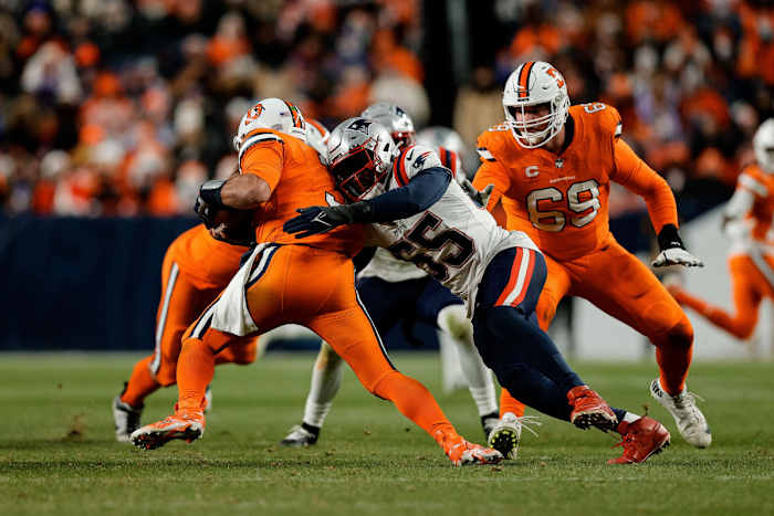 Dec 24, 2023; Denver, Colorado, USA; Denver Broncos quarterback Russell Wilson (3) is sacked by New England Patriots linebacker Josh Uche (55) as offensive tackle Mike McGlinchey (69) defends in the third quarter at Empower Field at Mile High. Mandatory Credit: Isaiah J. Downing-USA TODAY Sports